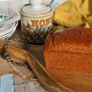 Gluten Free Honey Cake on a wooden board waiting to be sliced