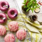 Guten Free Baked Doughnuts iced and drying on a cooling rack