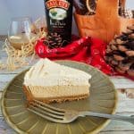 Slice of layered Baileys Baked Cheesecake made gluten free