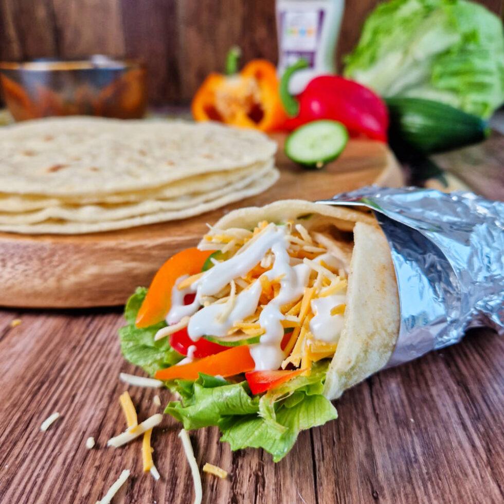 Gluten Free Tortilla Wrap filled with vegan cheese and salad