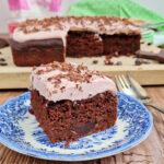 Dairy Free Chocolate Cherry Yogurt Cake also gluten free with yogurt buttercream on a blue tea plate